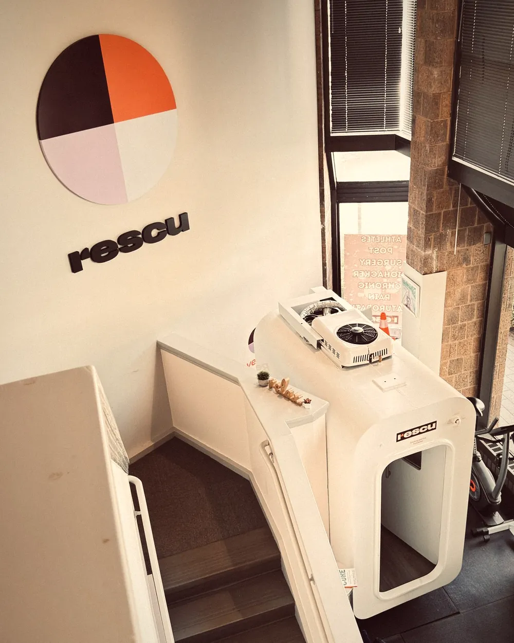 Hard-shell hyperbaric chamber at Rescu Wellness in Scarsdale, under the Rescu wall mark