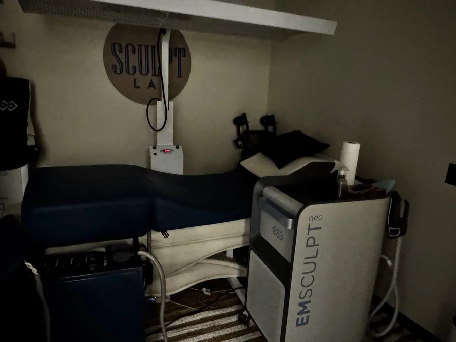 Emsculpt equipment next to a treatment bed in the body-treatment room