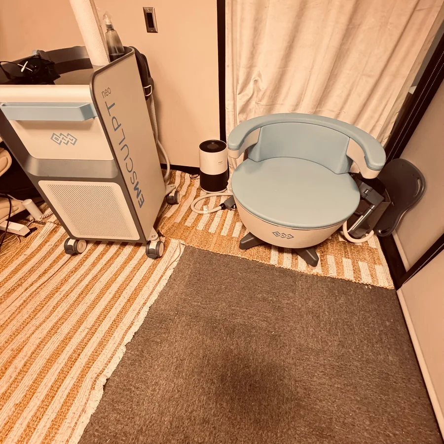 Blue Emsella chair beside Emsculpt equipment at Rescu